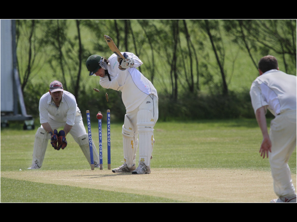 an image of a batsman being bowled out